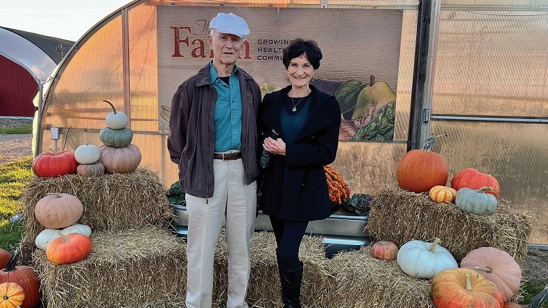 Herbert and Karla standing among pumpkins at The Farm