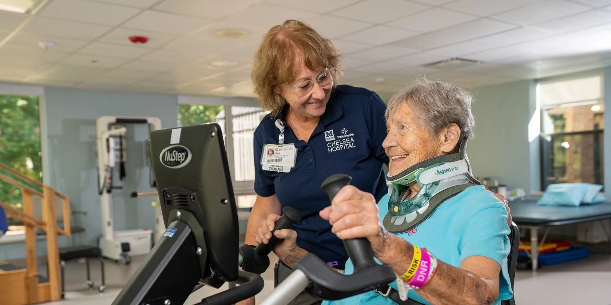 A woman provides rehab services to an older female patient
