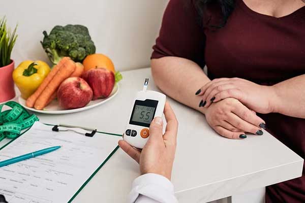 A provider holds a glucose monitor
